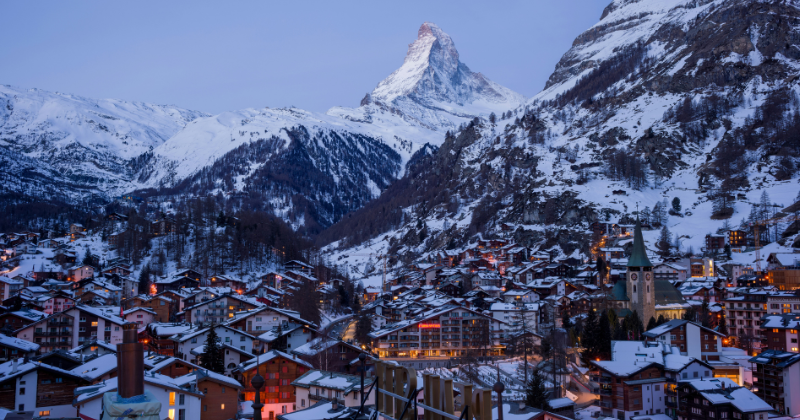 City at night under a mountain