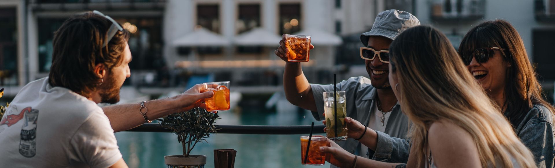 four friends cheering their drinks on holiday