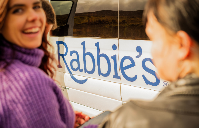 passengers outside rabbie's bus