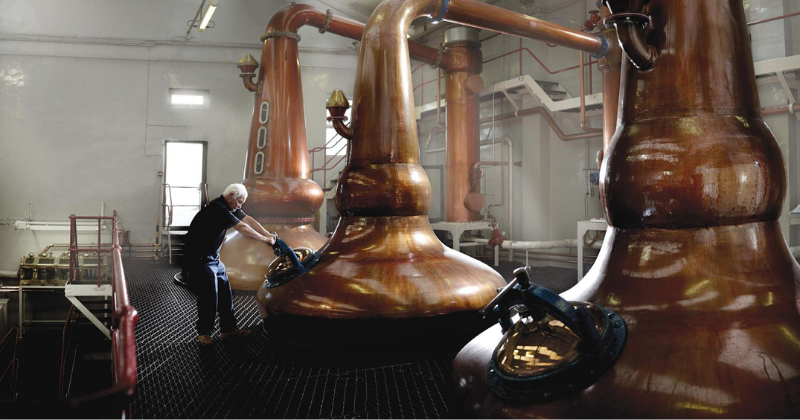 A man working in a whisky distillery