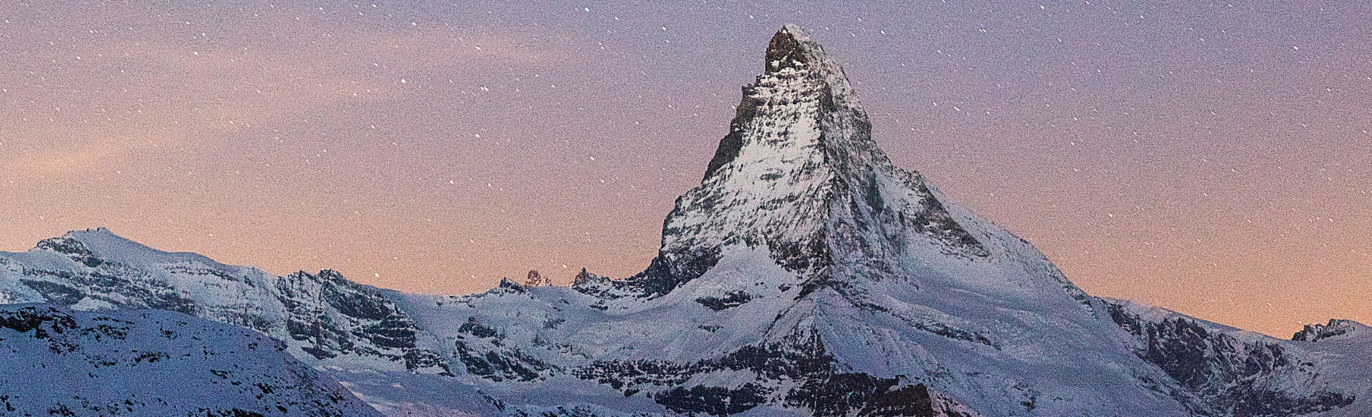 Matterhorn mountain backed by a starry sky