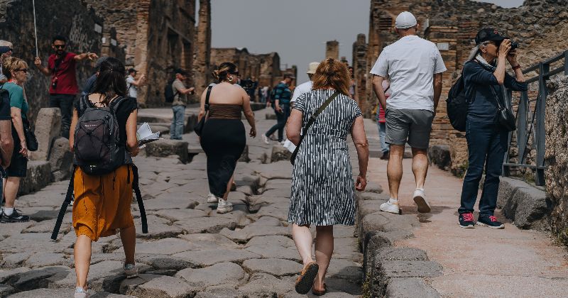 group of people wandering through Pompeii Italy