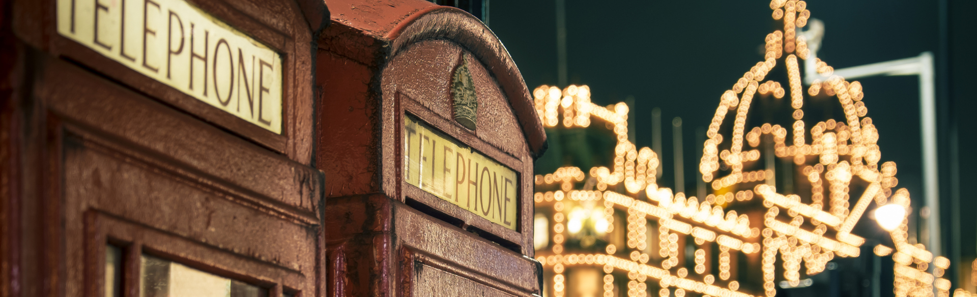 London phone boxes with Christmas lights in the background