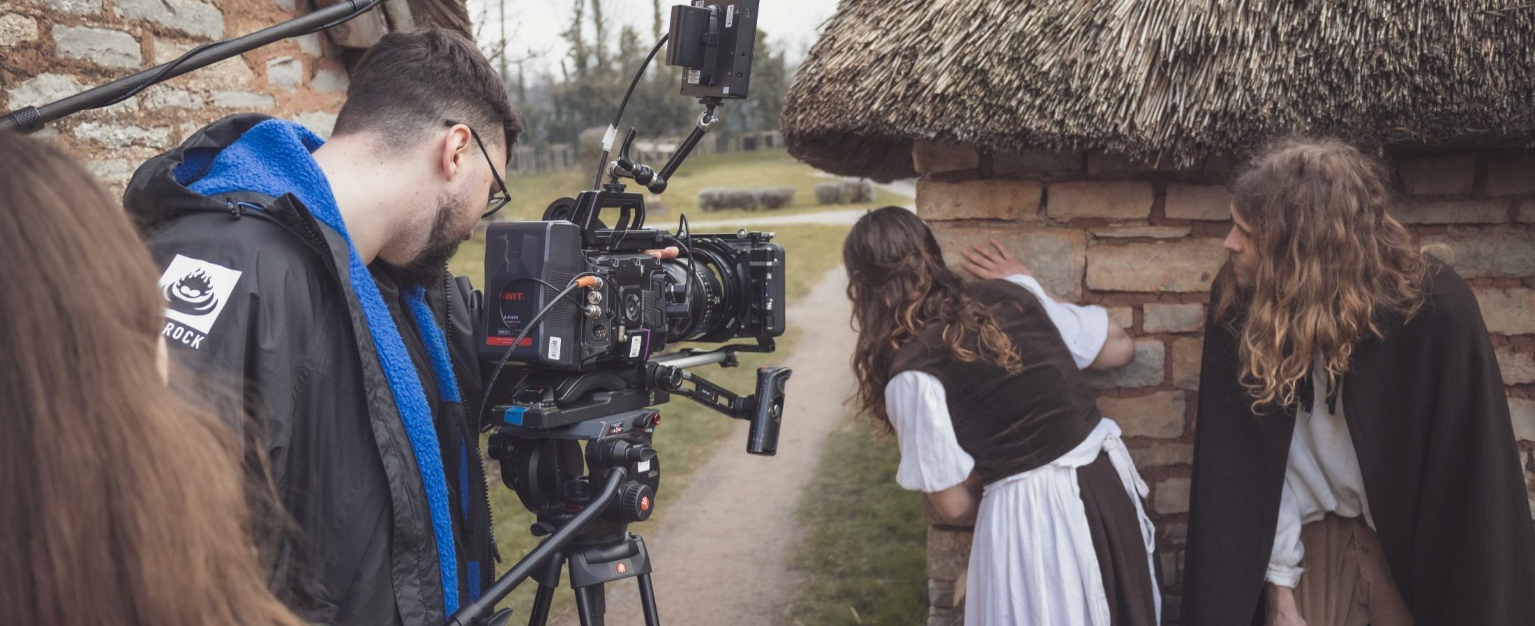 Man operating a film camera on a film set