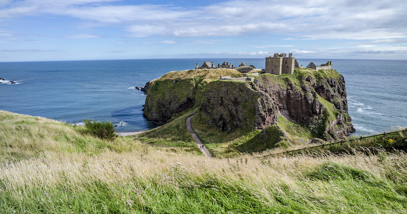 a view of Dunnottar Castle looking magnificent perched on a cliffedge on Scotland’s coast