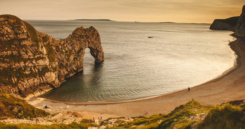 A scenic coastal view of Durdle Door, one of the most iconic natural stone arches in Britain.