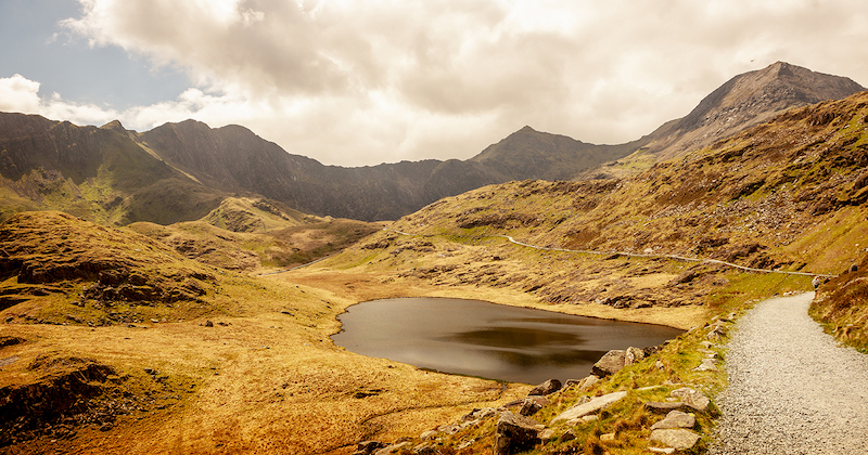 a track through the rugged landscape of Snowdonia National Park which can be visited on British tours.