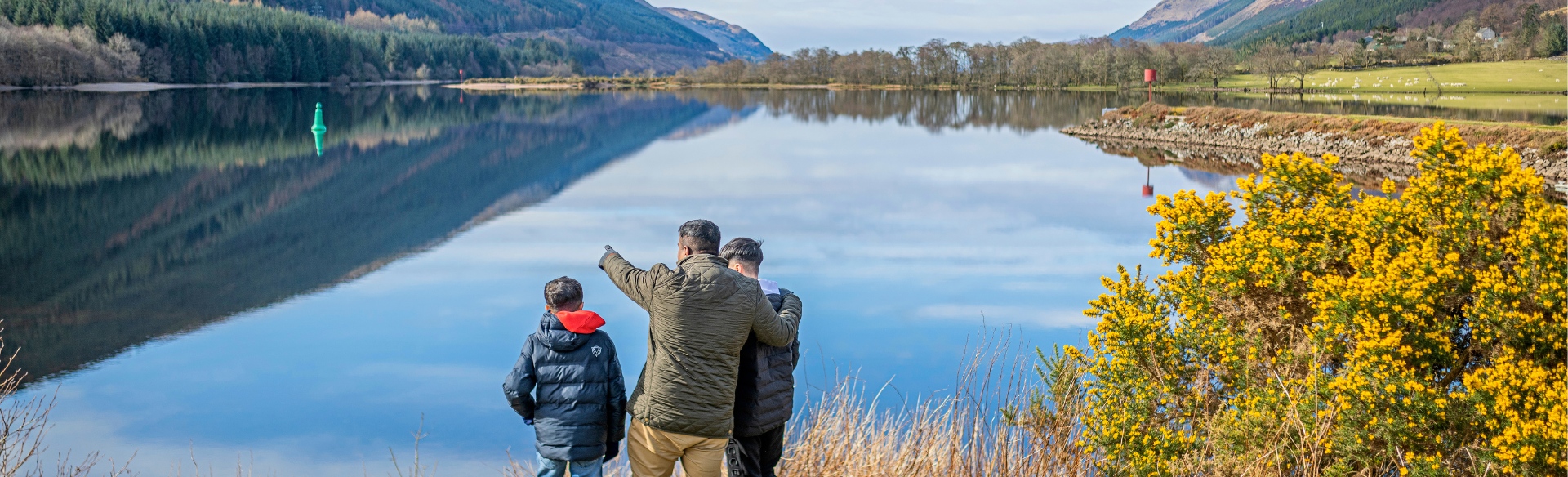 a family looking at a loch