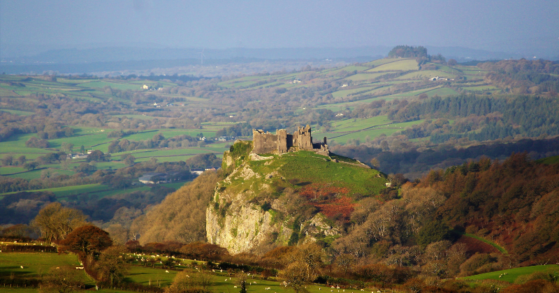 A castle on a hill top with surrounding countryside