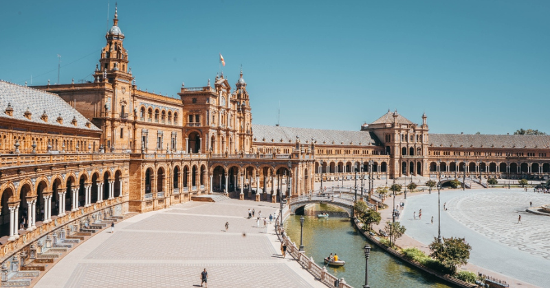 a stone courtyard surrounded by an impressive palace structure