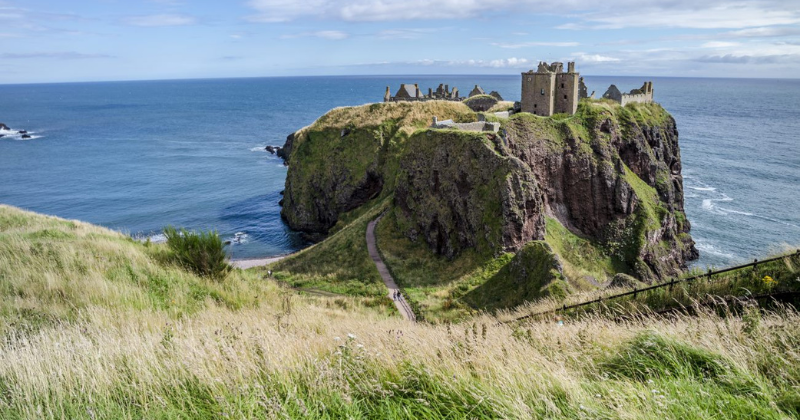 A castle on a rocky outcrop overlooking the ocean