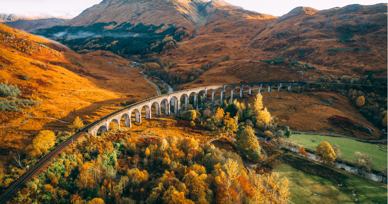 A stone viaduct over a rolling landscape