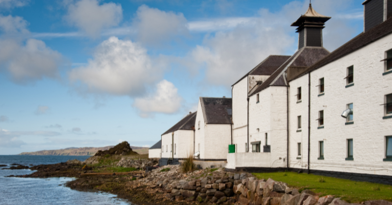 A white building sitting by the water's edge