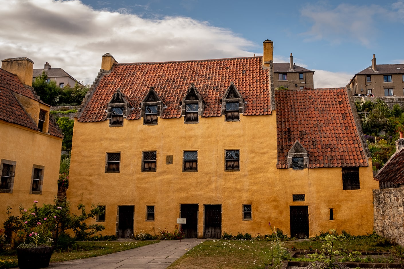 yellow brick building with red tiled roof located at Culross