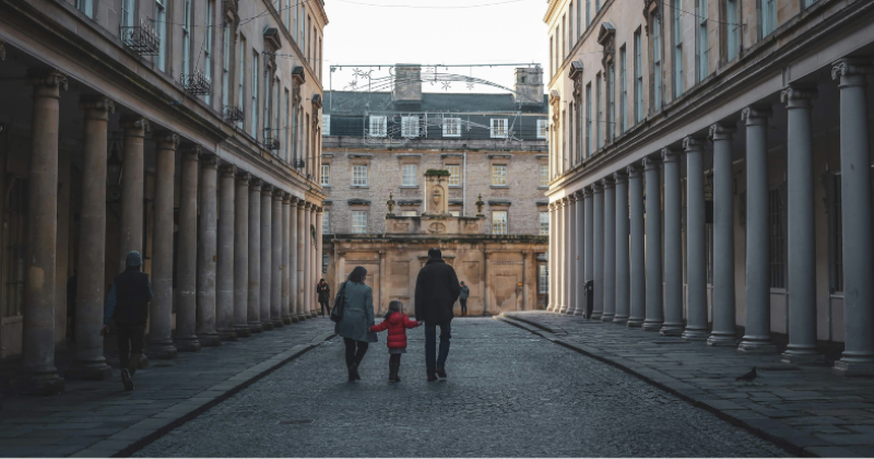 a family walking down a cobbled street